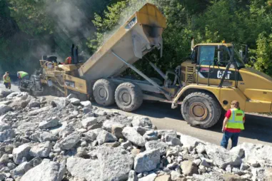 Construction machine with workers on Machinac Island trail